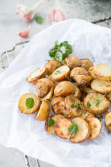 Baked potatoes in rustic style with green pesto sauce