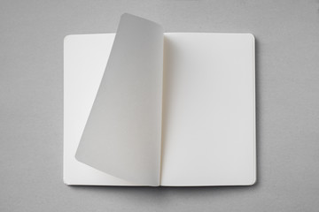 Fototapeta white notebook with turn page on grey background obraz