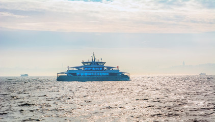 Muslim architecture and water transport in Turkey - Beautiful View touristic landmarks from sea voyage on Bosphorus. Cityscape of Istanbul at sunset - old mosque and turkish steamboats, view on Golden