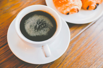 Coffee cup Americano with bakery Served on wooden table
