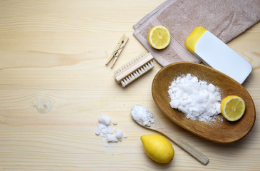 Eco friendly natural cleaners, washing soda, lemon, crystalic salt on a wooden background. Europe, Czech republic,