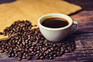 Coffee cup and coffee beans on table