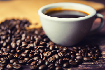 Coffee beans and coffee cup on table