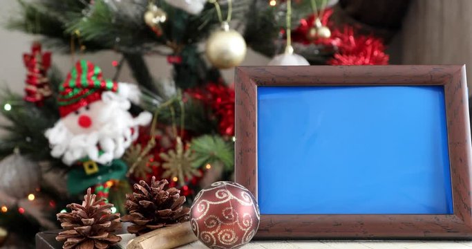 Empty Photo Frame in front of the christmas tree
