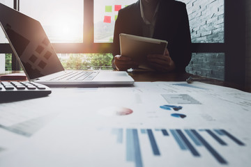 Economic research , Business woman analyzing income charts and graphs to plan marketing concept...