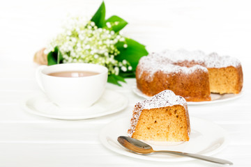 Bundt cake with sugar frosting. Spring breakfast set. Morning tea with flowers. Selected focus