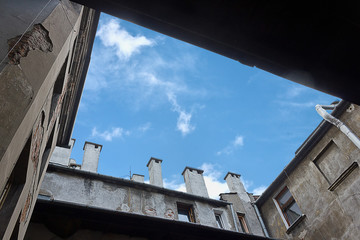 a piece of blue sky visible from the courtyard of an old house