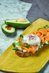 On a light gray background is a yellow plate with brockett. Beautiful serving of dishes. Restaurant menu