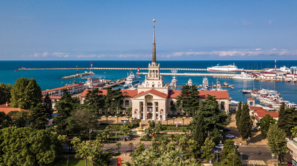 Obraz premium Aerial photography. Sea port with a bird's-eye view on a Sunny day. Yachts and boats are berthed. Promenade. Attraction of the city of Sochi. Ship Prince Vladimir in port.