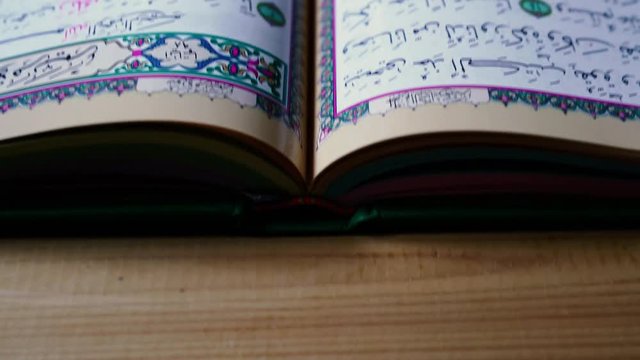 the holy Quran muslim holy book, detail of surah in slow motion, Holy Quran Kareem on wooden background with copy space, ramadan Kareem concept, 