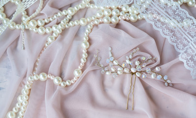 Wedding background with pearls and hair accessories on pink background