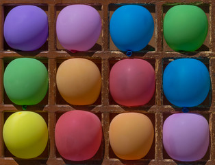 close up of dart game with color balloons