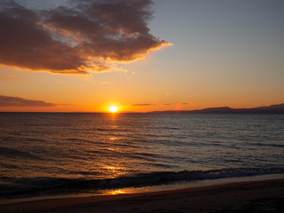 Amazing orange sunset on a beautiful empty beach