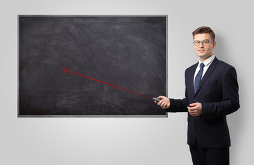 Handsome young teacher with laser pointer teaching 
