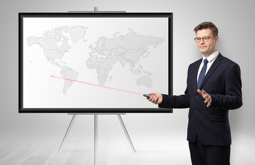 Handsome businessman with laser pointer  presenting potential business area on map
