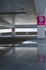 A wet and damp parking garage structure in the city parking area. 