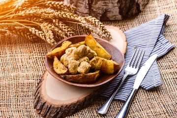 homemade potatoes and chicken on rustic background