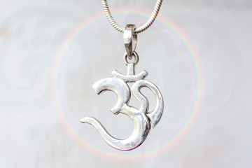 Silver om pendant on natural white background