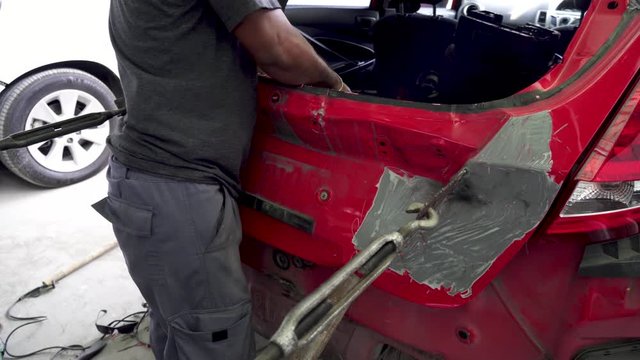 Car body work auto repair paint after the accident ,Align metal body car with hammer in automotive industry