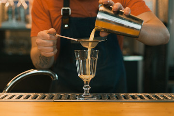 Barman making a cocktail at the bar