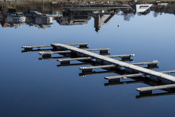 dock at a lake with reflections of the town