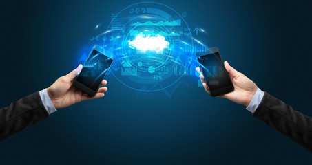 Two mobile phones syncing through the cloud