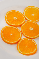 Fresh slised oranges isolated on the gray background