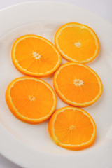 Fresh slised oranges isolated on the gray background