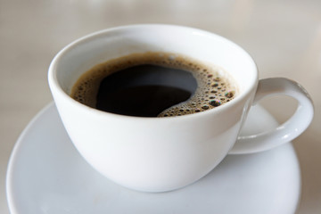 Hot Coffee in a White Cup on a White Table