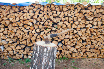 Axe in birch stump. Harvesting wood for the winter. Wooden background