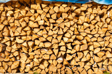 Woodpile of birch firewood. Preparation of wood for the oven. wood background. Preparation for winter