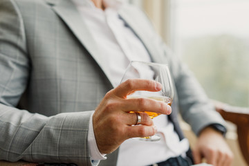 Obraz na płótnie Canvas a glass of whiskey in the hands of a man