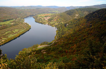 Fototapeta na wymiar Aerial panoramic view on Ain River in France surrounded by autumn forest.