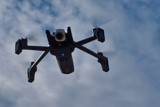 Parrot Anafi drone flying against cloudy blue sky