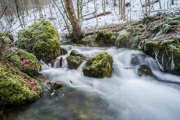 Cold forest river in long exposure. Winter cold season
