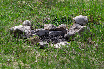 Fototapeta na wymiar coals that remained from the fire on the grass