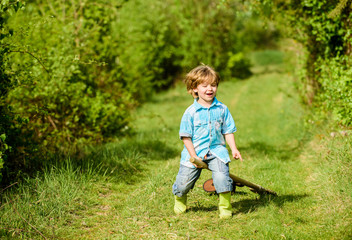 small kid play with shovel. ecology and environmental protection. earth day. farming equipment. summer fun. happy child gardener. spring country side village. little kid having fun. nature and human