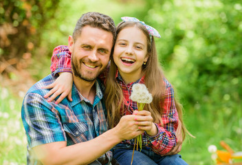 Seasonal allergies concept. Outgrow allergies. Happy family vacation. Father and little girl enjoy summertime. Dad and daughter blowing dandelion seeds. Keep allergies from ruining your life