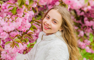 Fototapeta premium Bright and vibrant. Soft and tender. Pink is on my mind. Pink is my favorite. Little girl enjoy spring. Kid pink flowers of sakura tree garden. Kid enjoying pink cherry blossom. Tender bloom