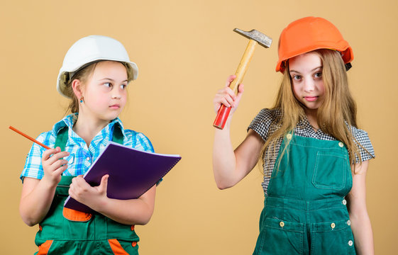 Little kids in helmet with hammer. Labor day. 1 may. happy children. Future career. Foreman inspector. Repair. small girls repairing together in workshop. Feeling tired after hard day in repair shop