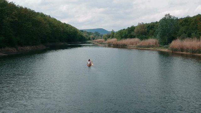 Couple paddling in a wooden canoe