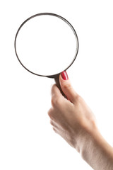 Female hand holding magnifying glass isolated on white background.
