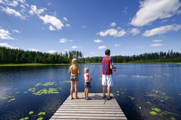 family fishing at lake in the summer sunny day - 267073694