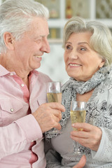 Close-up portrait of mature couple drinking champagne
