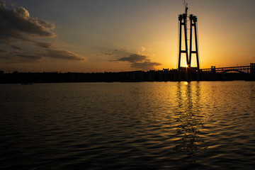 Sunset over the river Dnieper. Bridge.