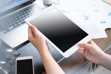 Business concept. Woman using tablet for project with digital device in office desk. Backlighting, sun glare effect, close up, side view, copy space