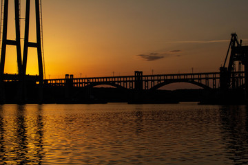 Naklejka na ściany i meble Sunset over the river Dnieper. Bridge.
