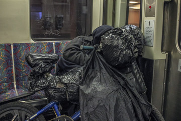 Homeless vagrant on subway train