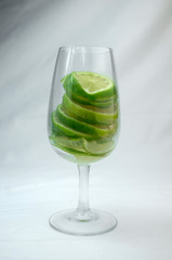glass of  lime and ice on wooden background