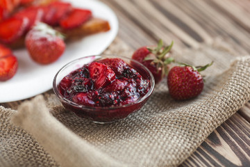 Morning breakfast. Toasts with strawberry and jam. Bread and confiture. Fresh hot toasts with cream. Delicious homemade dessert.